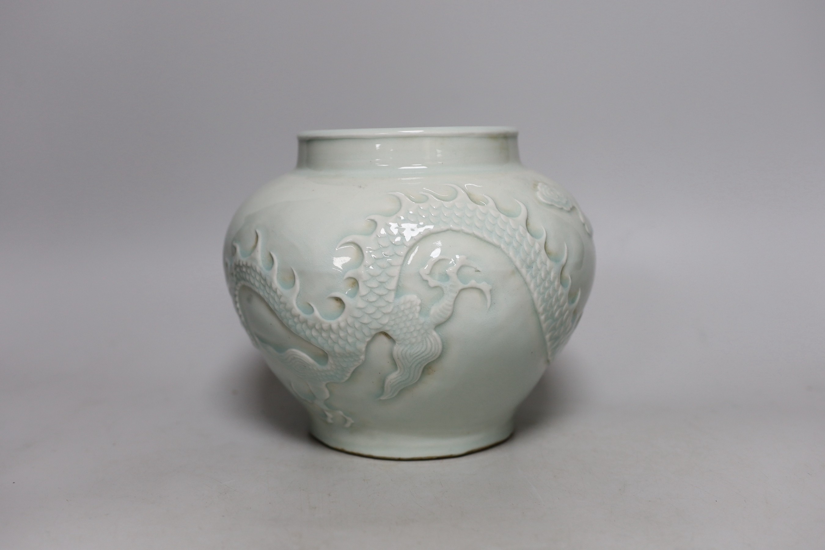 A Chinese relief moulded ‘dragon’ vase, 17cms